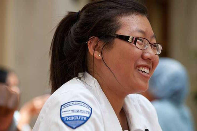 Close-up photo of a Case Western Reserve University nursing student wearing scrubs, smiling